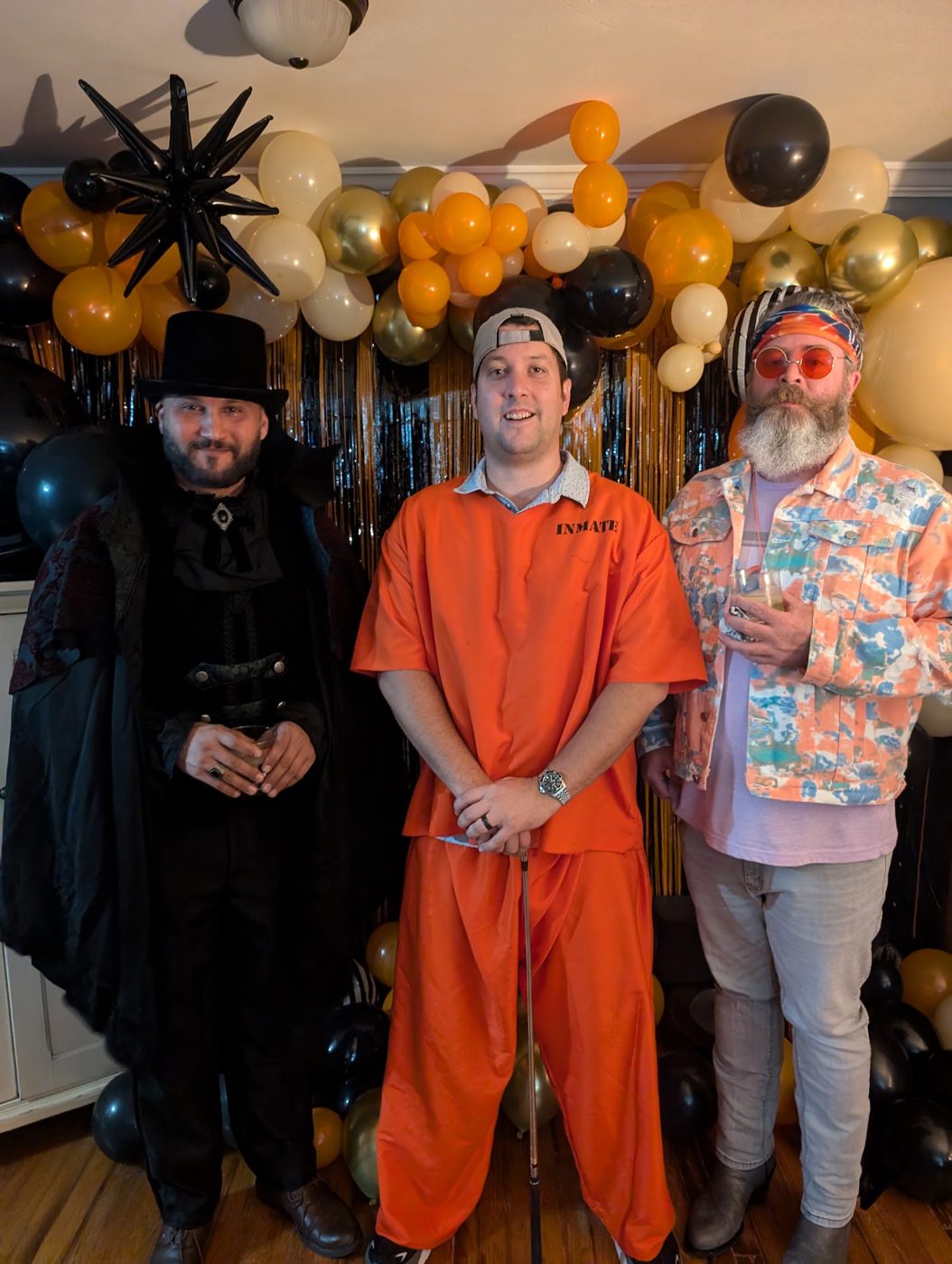A vampire, a prisoner in orange and a guy in a Hawaiian shirt